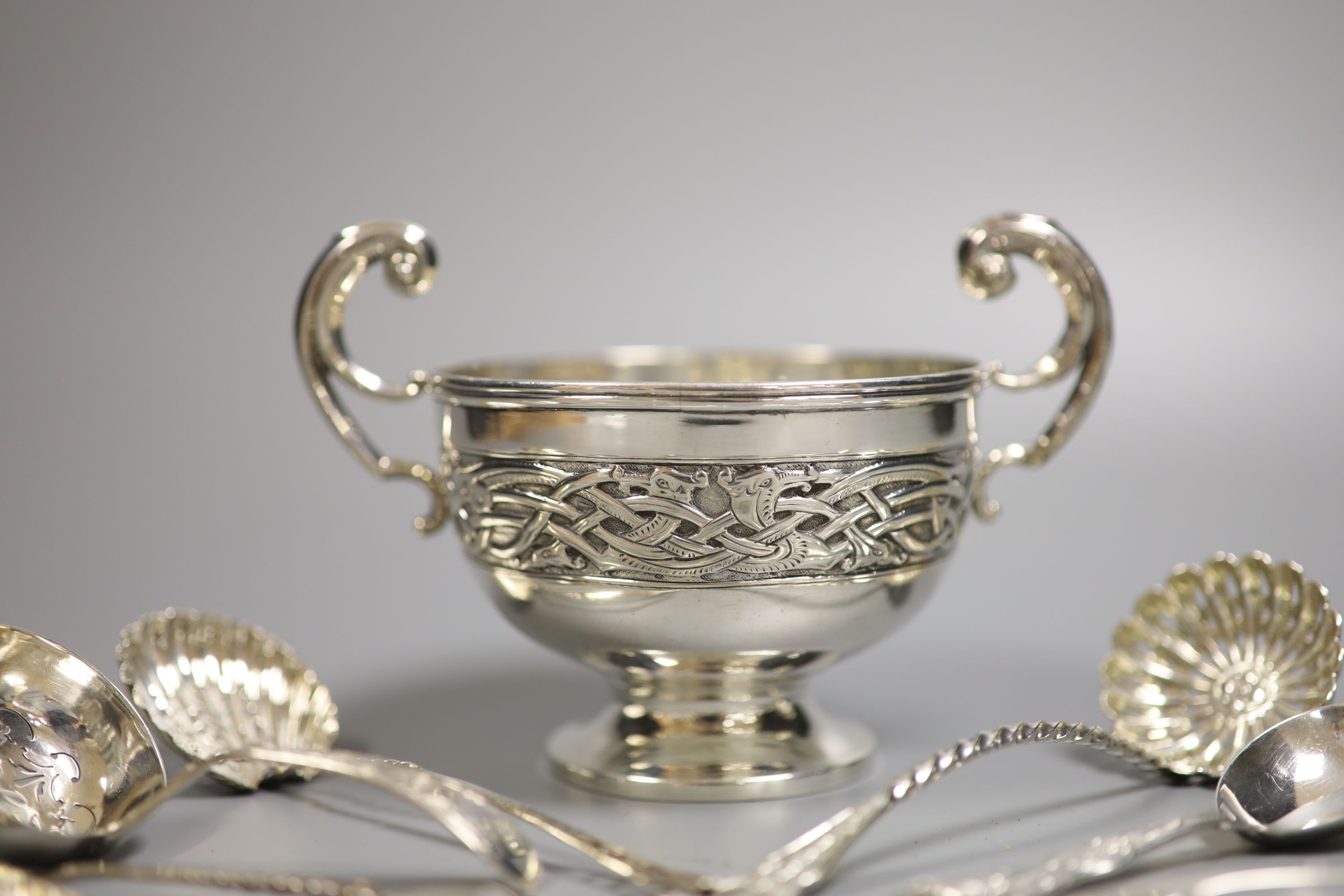 A George V silver Art Nouveau two handled bowl, Birmingham, 1912, height 11.3cm and seven items of silver flatware, 9.5oz.